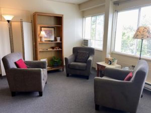 Three chairs facing each other near a window in Tamara's office